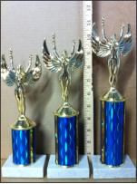 Three trophies on blue post ranging in size, with a victory trophy topper.